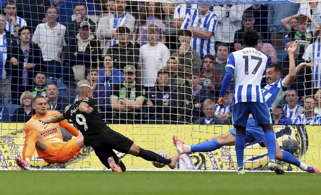 Tottenham Hotspur's Richarlison, second left, scores his sides first goal during English Premier League soccer match between Brighton and Tottenham Hotspur match at the American Express Stadium in Brighton, England on Saturday Sept. 20, 2025. (Gareth Fuller/PA via AP)