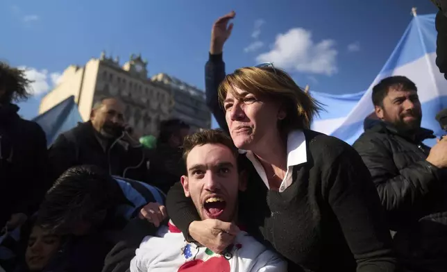 Miriam Espinosa celebrates with his son Matias Ramon Day, after senators rejected President Javier Milei's veto of a bill to expand protections for people with disabilities, in Buenos Aires, Argentina, Thursday, Sept. 4, 2025. (AP Photo/Victor R. Caivano)