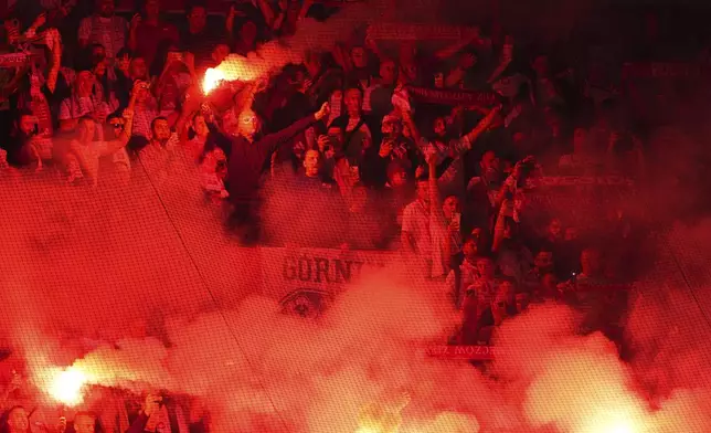 Poland fans light torches during a World Cup qualifying soccer match between the Netherlands and Poland in Rotterdam, Netherlands, Thursday, Sept. 4, 2025. (AP Photo/Peter Dejong)