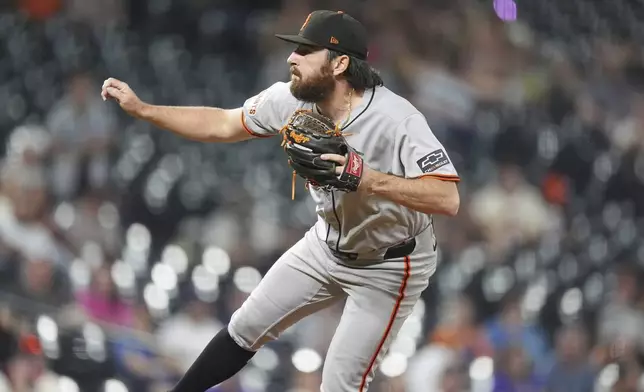 San Francisco Giants relief pitcher Ryan Walker works against the Colorado Rockies in the ninth inning of a baseball game Wednesday, Sept. 3, 2025, in Denver. (AP Photo/David Zalubowski)