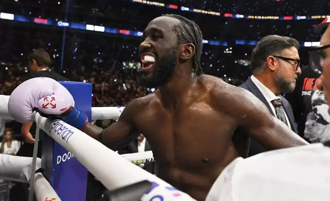 Terence Crawford celebrates after defeating Canelo Alvarez by unanimous decision in an undisputed super middleweight championship boxing match in Las Vegas, Saturday, Sept. 13, 2025. (AP Photo/David Becker)