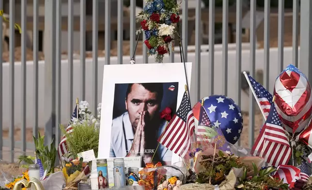 A makeshift memorial grows in size at the Turning Point USA headquarters after the shooting death at a Utah college last Wednesday of Charlie Kirk, the 31-year-old founder and CEO of the organization, Wednesday, Sept. 17, 2025, in Phoenix. (AP Photo/Ross D. Franklin)