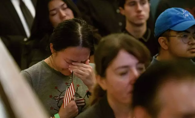 People sing and pray during a memorial and prayer vigil for Charlie Kirk at the John F. Kennedy Memorial Center for the Performing Arts, Sunday, Sept. 14, 2025, in Washington. (AP Photo/Rod Lamkey, Jr.)