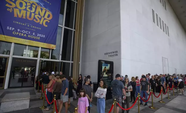 People wait in line for a memorial and prayer vigil for Charlie Kirk at the John F. Kennedy Memorial Center for the Performing Arts, Sunday, Sept. 14, 2025, in Washington. (AP Photo/Rod Lamkey, Jr.)