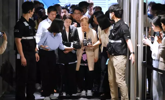 Hak Ja Han, center, the leader of South Korea's Unification Church, is questioned by reporters upon arrival at a special prosecutor's office in Seoul, South Korea, Wednesday, Sept. 17, 2025. (AP Photo/Lee Jin-man)