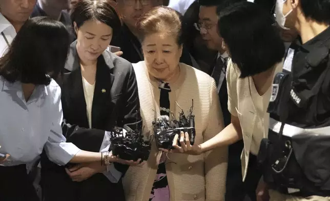 Hak Ja Han, center, the leader of South Korea's Unification Church, arrives at a special prosecutor's office in Seoul, South Korea, Wednesday, Sept. 17, 2025. (AP Photo/Lee Jin-man)