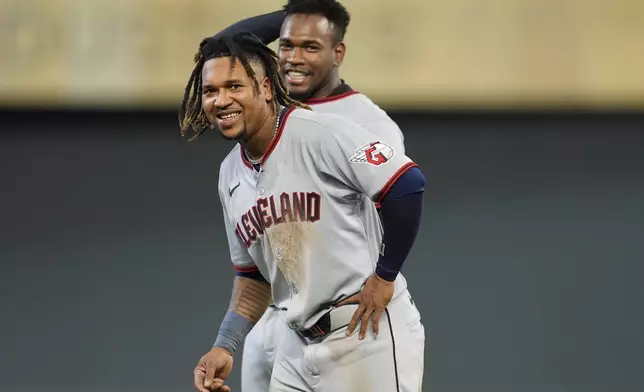 Cleveland Guardians third baseman José Ramírez, left and Angel Martínez look toward the dugout in the nineth inning of a baseball game against the Minnesota Twins, Friday, Sept. 19, 2025, in Minneapolis. (AP Photo/Mike Stewart)