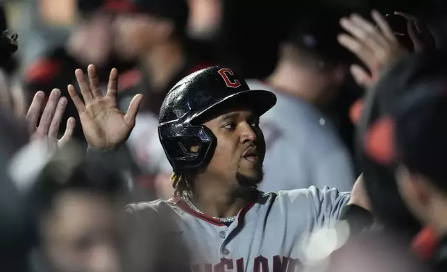 Cleveland Guardians third baseman José Ramírez (11) celebrates scoring off the bat of Bo Naylor in the first inning of a baseball game against the Minnesota Twins, Friday, Sept. 19, 2025, in Minneapolis. (AP Photo/Mike Stewart)