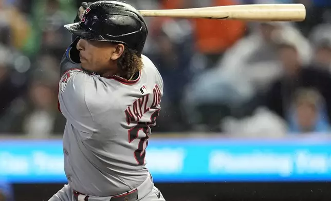Cleveland Guardians' Bo Naylor (23) hits a two-RBI single against the Minnesota Twins in the first inning of a baseball game, Friday, Sept. 19, 2025, in Minneapolis. (AP Photo/Mike Stewart)