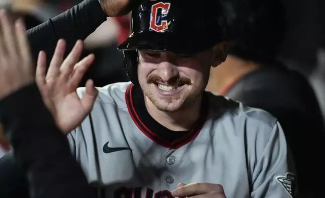 Cleveland Guardians' Kyle Manzardo celebrates scoring off the bat of Bo Naylor in the eighth inning of a baseball game against the Minnesota Twins, Friday, Sept. 19, 2025, in Minneapolis. (AP Photo/Mike Stewart)