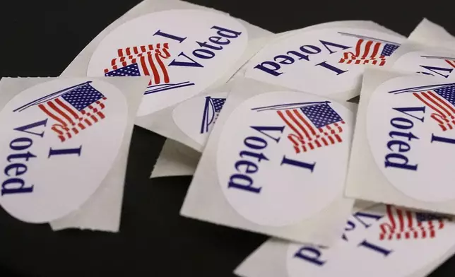 "I Voted" stickers rest on a ballot box at a polling place, Tuesday, Sept. 9, 2025, in the Roslindale neighborhood of Boston. (AP Photo/Charles Krupa)