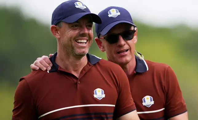 Europe captain Luke Donald and Rory McIlroy celebrates after a putt on the 15th hole at Bethpage Black golf course during the Ryder Cup golf tournament, Saturday, Sept. 27, 2025, in Farmingdale, N.Y. (AP Photo/Matt Slocum)