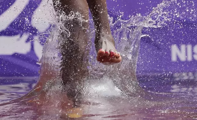 Kazakhstan's Daisy Jepkemei competes in a heat of the women's 3,000 meters steeplechase after losing a shoe at the World Athletics Championships in Tokyo, Monday, Sept. 15, 2025. (AP Photo/Ashley Landis)