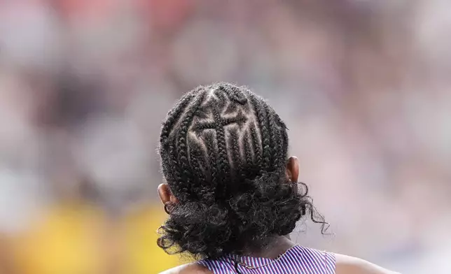 The hair of United States' Melissa Jefferson-Wooden as she competes in the women's 100 meters semifinal heat at the World Athletics Championships in Tokyo, Sunday, Sept. 14, 2025. (AP Photo/Eugene Hoshiko)