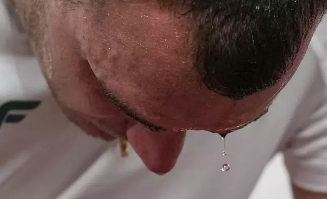 Hungary's Bence Halasz rests in the men's hammer throw final at the World Athletics Championships in Tokyo, Tuesday, Sept. 16, 2025. (AP Photo/Ashley Landis)