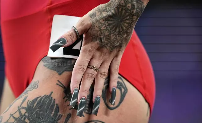 Poland's Ewa Swoboda displays body art after finishing a women's 100 meters heat at the World Athletics Championships in Tokyo, Saturday, Sept. 13, 2025. (AP Photo/Petr David Josek)