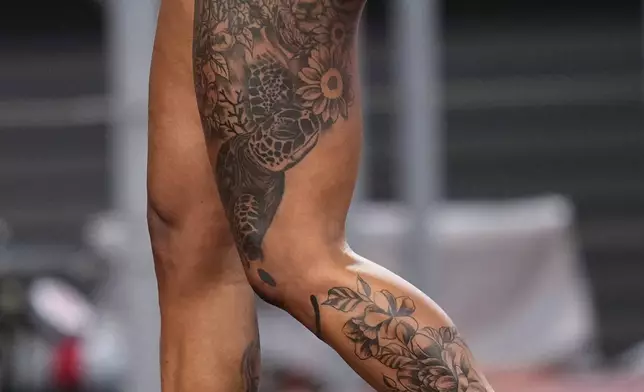 Tattoos are seen on the legs of Jamaica's Ashanti Moore during women's 200 meters semifinal at the World Athletics Championships in Tokyo, Thursday, Sept. 18, 2025. (AP Photo/Eugene Hoshiko)
