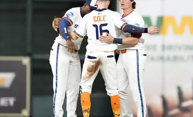 Houston Astros right fielder Jesus Sanchez, left, right fielder Zachary Cole (16), and center fielder Jake Meyers, right, celebrate after their win over the Texas Rangers in a baseball game Monday, Sept. 15, 2025, in Houston. (AP Photo/Karen Warren)