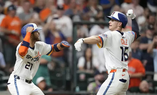 Houston Astros' Zachary Cole, right, celebrates with Jeremy Peña, left, after hitting two-run home run off Texas Rangers starting pitcher Jack Leiter during the fifth inning of a baseball game Monday, Sept. 15, 2025, in Houston. (AP Photo/Karen Warren)