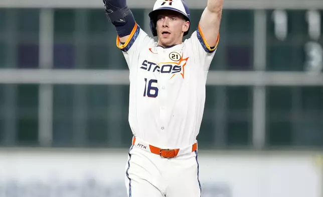 Houston Astros' Zachary Cole celebrates at second base after his RBI single off Texas Rangers relief pitcher Jacob Webb during the seventh inning of a baseball game Monday, Sept. 15, 2025, in Houston. (AP Photo/Karen Warren)
