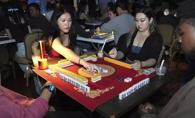 People play mahjong at an event organized by the YLL Mahjong Club on Friday, Aug. 15, 2025, in San Francisco. (AP Photo/Terry Chea)