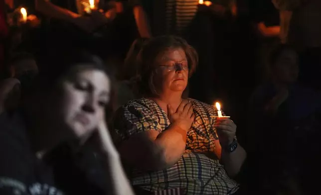 Ginger Keller pays her respects during a vigil for Charlie Kirk on Friday, Sept. 12, 2025, in Provo, Utah. (AP Photo/Lindsey Wasson)