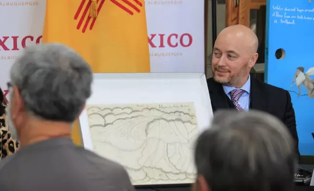 Justin Garris, Special Agent in Charge of the FBI Albuquerque field office, listens to a presentation on a centuries-old map during a ceremony in Albuquerque, New Mexico, on Tuesday, Sept. 23, 2025. (AP Photo/Susan Montoya Bryan)