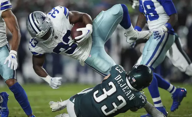 Dallas Cowboys running back Javonte Williams (33) is upended by Philadelphia Eagles cornerback Cooper DeJean (33) as Williams runs the ball in the second half of an NFL football game Thursday, Sept. 4, 2025, in Philadelphia. (AP Photo/Matt Slocum)