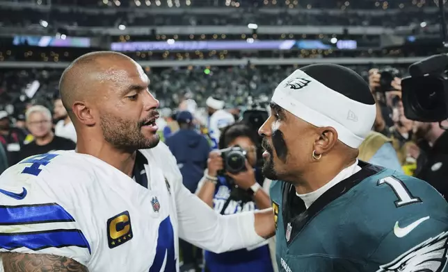 Dallas Cowboys quarterback Dak Prescott (4) and Philadelphia Eagles quarterback Jalen Hurts (1) talk after their team's NFL football game Friday, Sept. 5, 2025, in Philadelphia. (AP Photo/Matt Rourke)