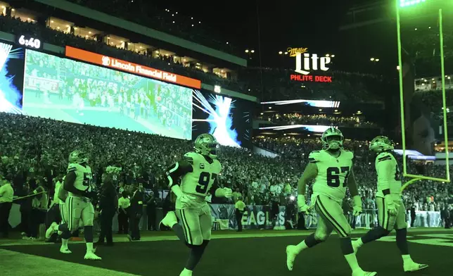 The Dallas Cowboys jog onto the field for the first half of an NFL football game against the Philadelphia Eagles Thursday, Sept. 4, 2025, in Philadelphia. (AP Photo/Matt Rourke)
