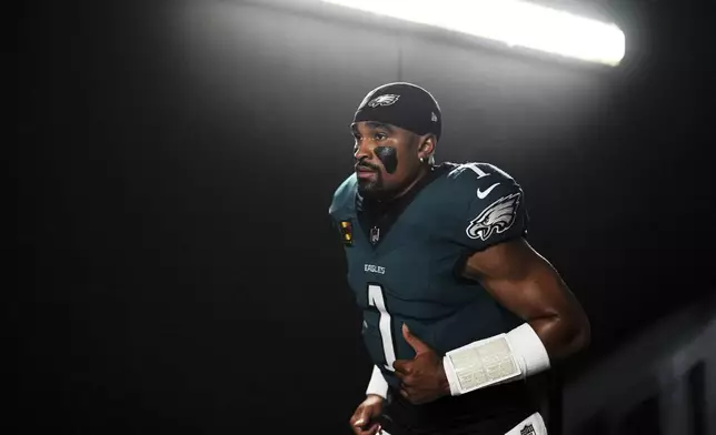Philadelphia Eagles quarterback Jalen Hurts jogs down a tunnel before an NFL football game against the Dallas Cowboys Thursday, Sept. 4, 2025, in Philadelphia. (AP Photo/Matt Slocum)
