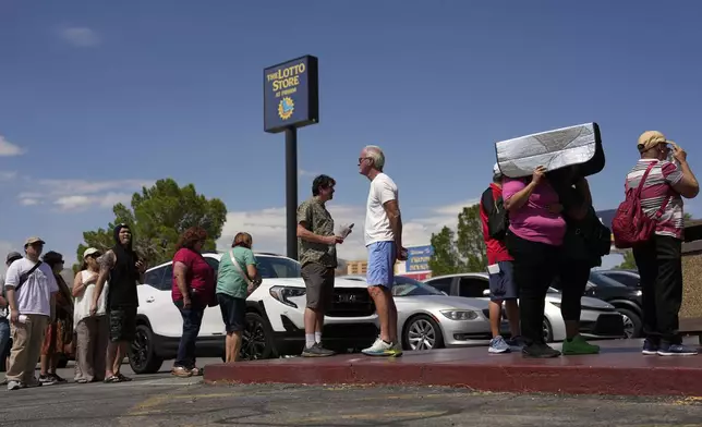 People wait in line to buy lottery tickets at the Lotto Store just inside the California border, Wednesday, Sept. 3, 2025, near Primm, Nev. (AP Photo/John Locher)