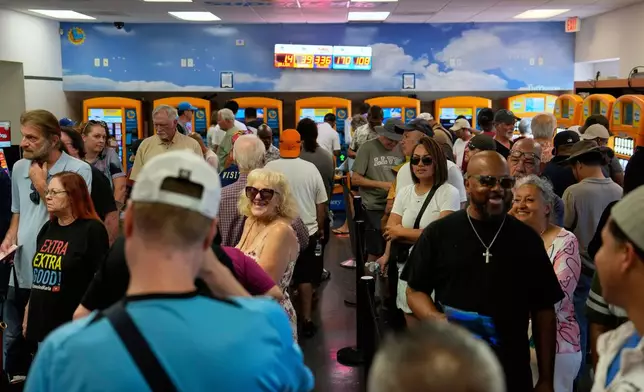People wait in line to buy lottery tickets at the Lotto Store just inside the California border, Wednesday, Sept. 3, 2025, near Primm, Nev. (AP Photo/John Locher)