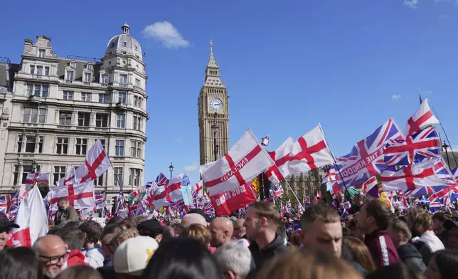 People demonstrate during the Tommy Robinson-led Unite the Kingdom march and rally, in London, Saturday Sept. 13, 2025. (AP Photo/Joanna Chan)