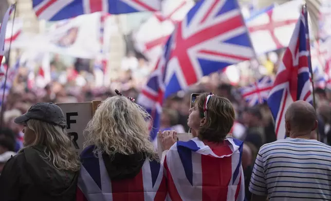 People demonstrate during the Tommy Robinson-led Unite the Kingdom march and rally, in London Saturday Sept. 13, 2025. (AP Photo/Joanna Chan)
