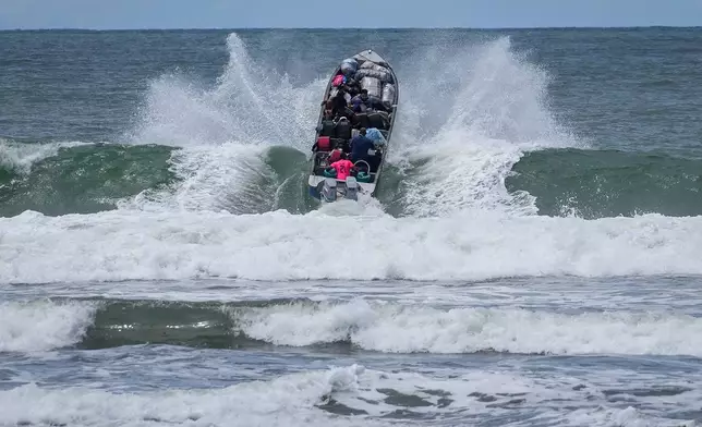 Venezuelan migrants depart Jaque on Panama's Pacific coast en route to Jurado, Colombia, as they return home after failing to enter the United States, Friday, Sept. 19, 2025. (AP Photo/Matias Delacroix)