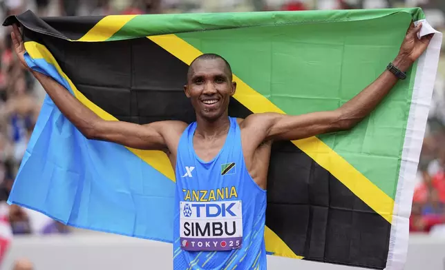 Tanzania's Alphonce Felix Simbu poses after winning the gold medal in the men's marathon ahead of Germany's Amanal Petros at the World Athletics Championships in Tokyo, Monday, Sept. 15, 2025. (AP Photo/Matthias Schrader)
