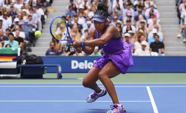 Naomi Osaka, of Japan, returns a shot against Coco Gauff, of the United States, during the fourth round of the US Open tennis championships, Monday, Sept. 1, 2025, in New York. (AP Photo/Kirsty Wigglesworth)