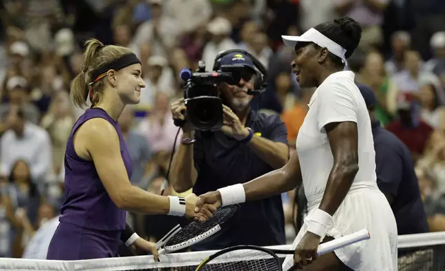 Karolina Muchova, of the Czech Republic, shakes hands with Venus Williams, of the United States, during the first round of the U.S. Open tennis championships, Monday, Aug. 25, 2025, in New York. (AP Photo/Adam Hunger)