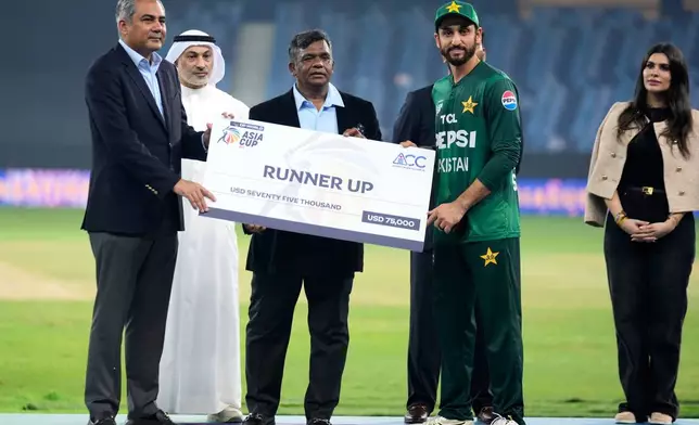 Pakistan's captain Salman Agha receives the runner up award after India won the Asia Cup cricket final against Pakistan at Dubai International Cricket Stadium, United Arab Emirates, Sunday, Sept. 28, 2025. (AP Photo/Altaf Qadri)