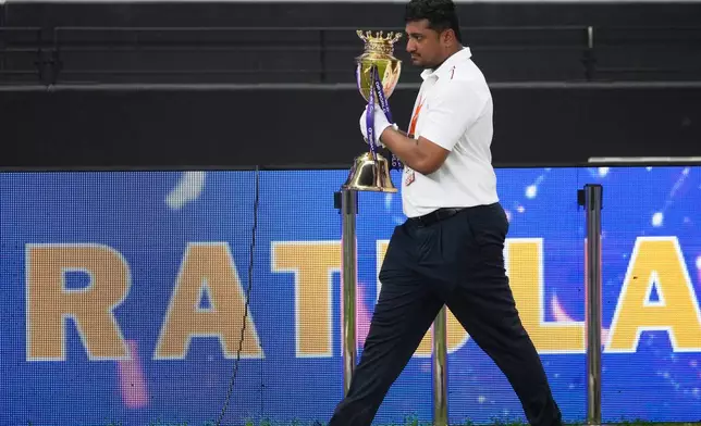 An official removes the winners' trophy from the presentation area after India won the Asia Cup cricket final against Pakistan at Dubai International Cricket Stadium, United Arab Emirates, Sunday, Sept. 28, 2025. (AP Photo/Altaf Qadri)