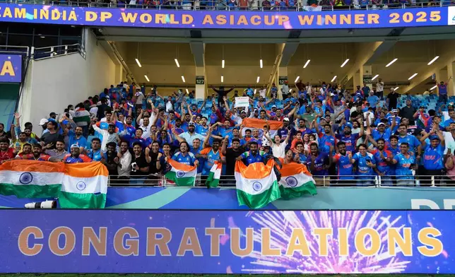 Fans celebrate after India won the Asia Cup cricket final against Pakistan at Dubai International Cricket Stadium, United Arab Emirates, Sunday, Sept. 28, 2025. (AP Photo/Altaf Qadri)