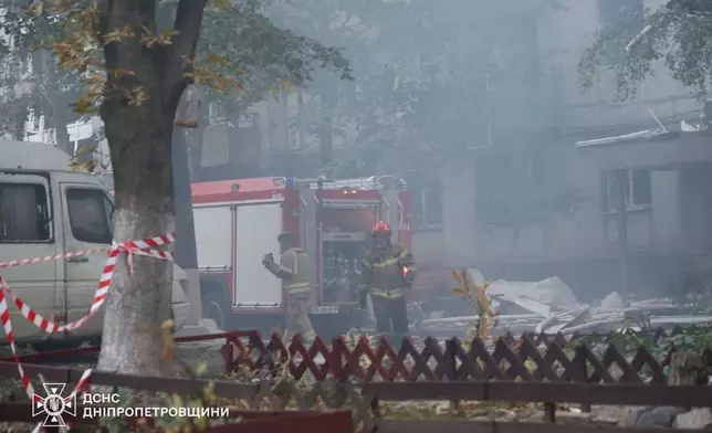 In this photo provided by the Ukrainian Emergency Services on Saturday, Sept. 20, 2025, rescue workers put out a fire of a residential house damaged by a Russian strike on Dnipro, Ukraine. (Ukrainian Emergency Service via AP)