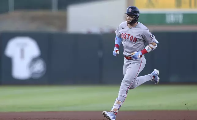 Boston Red Sox's Trevor Story jogs around the bases after hitting a solo home during the first inning of a baseball game against the Athletics, Monday, Sept. 8, 2025, in West Sacramento, Calif. (AP Photo/Scott Marshall)