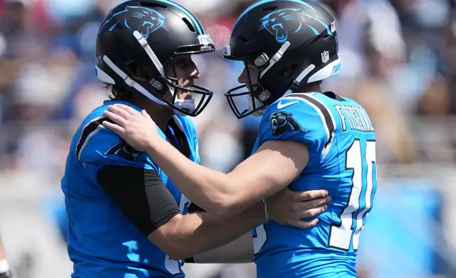 Carolina Panthers kicker Ryan Fitzgerald celebrates after kicking a field goal with Nic Scourton against the Atlanta Falcons during the first half of an NFL football game, Sunday, Sept. 21, 2025, in Charlotte, N.C. (AP Photo/Jacob Kupferman)