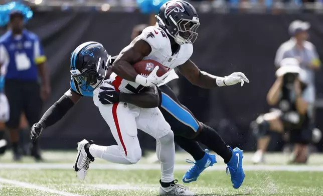Atlanta Falcons running back Nate Carter is tackled by Carolina Panthers' Bam Martin-Scott during the second half of an NFL football game, Sunday, Sept. 21, 2025, in Charlotte, N.C. (AP Photo/Rusty Jones)