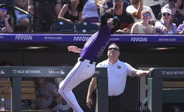 Colorado Rockies third baseman Kyle Karros pulls in a pop foul off the bat of San Francisco Giants' Willy Adames to end the top of the third inning of a baseball game Monday, Sept. 1, 2025, in Denver. (AP Photo/David Zalubowski)