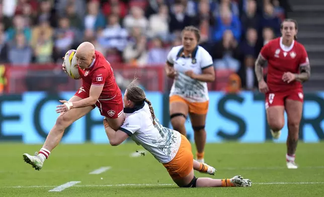 Canada's Olivia Apps is tackled by Australia's Caitlyn Halse during the Women's Rugby World Cup quarterfinal match, Saturday, Sept. 13, 2025, at Ashton Gate, Bristol, England. (Andrew Matthews/PA via AP)