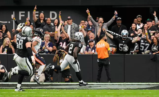 Fans cheer as Las Vegas Raiders running back Ashton Jeanty (2) runs for a touchdown during the first half of an NFL football game against the Chicago Bears Sunday, Sept. 28, 2025, in Las Vegas. (AP Photo/John Locher)