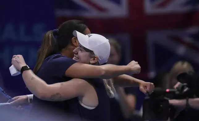 Sonay Kartal, of Great Britain, right, celebrates with her team captain Anne Keothavong after defeating Ena Shibahara, of Japan in the Billie Jean King Cup quarterfinals tennis match, at the Shenzhen Bay Sports Center Arena, in Shenzhen, China's Guangdong province, Thursday, Sept. 18, 2025. (AP Photo/Andy Wong)